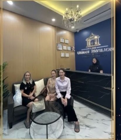 Reception desk with the gold Urban Pavilions crest on a navy wall